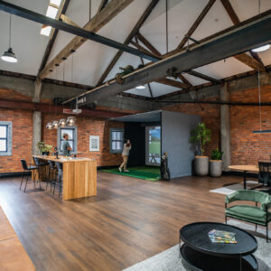 Man enjoying golf simulator at work